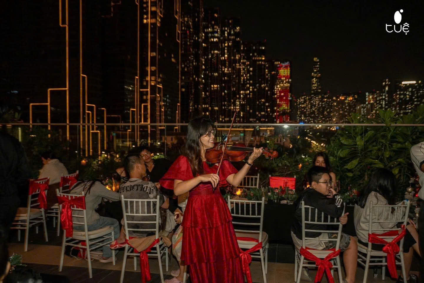 Hạ Vy — Violin with a rooftop skyline backdrop